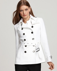 White twill offers up a clean, refreshing slate on this Burberry Brit jacket, featuring a double breasted and belted silhouette.