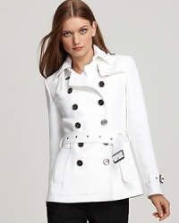 White twill offers up a clean, refreshing slate on this Burberry Brit jacket, featuring a double breasted and belted silhouette. White twill offers up a clean, refreshing slate on this Burberry Brit jacket, featuring a double breasted and belted silhouette.