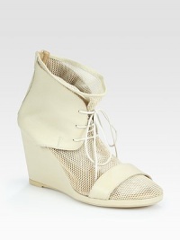 Urban-cool mesh design with a lace-up front and soft leather trim. Self-covered wedge, 3½ (90mm)Mesh and leather upperBack zipperLeather liningRubber soleMade in ItalyOUR FIT MODEL RECOMMENDS ordering one half size up as this style runs small. Urban-cool mesh design with a lace-up front and soft leather trim. Self-covered wedge, 3½ (90mm)Mesh and leather upperBack zipperLeather liningRubber soleMade in ItalyOUR FIT MODEL RECOMMENDS ordering one half size up as this style runs small.