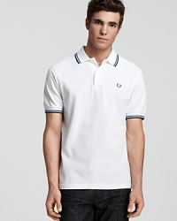 Widely known as the pioneer of Mod, British street fashion, Fred Perry polos have become an iconic fashion silhouette. A sporty polo with contrast double stripe trim and embroidered logo at left chest. Slim fit. Widely known as the pioneer of Mod, British street fashion, Fred Perry polos have become an iconic fashion silhouette. A sporty polo with contrast double stripe trim and embroidered logo at left chest. Slim fit.