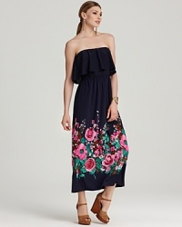 A bold take on femininity, this DKNY maxi dress showcases a graphic floral motif against a floor-sweeping silhouette for a maximum impact look. A bold take on femininity, this DKNY maxi dress showcases a graphic floral motif against a floor-sweeping silhouette for a maximum impact look.