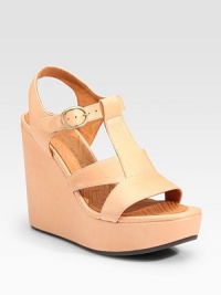 Chunky leather t-strap wedge secured by an adjustable ankle strap. Self-covered wedge, 4½ (115mm)Island platform, 1 (25mm)Compares to a 3½ heel (90mm)Leather upperLeather liningRubber solePadded insoleImportedOUR FIT MODEL RECOMMENDS ordering one half size up as this style runs small. Chunky leather t-strap wedge secured by an adjustable ankle strap. Self-covered wedge, 4½ (115mm)Island platform, 1 (25mm)Compares to a 3½ heel (90mm)Leather upperLeather liningRubber solePadded insoleImportedOUR FIT MODEL RECOMMENDS ordering one half size up as this style runs small.