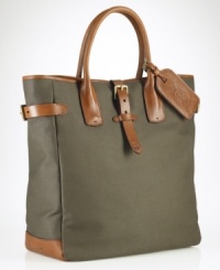 A superior carryall for daily essentials, a polished canvas bag is constructed with saddle-inspired leather trim and comfortable rolled handles and features organizational interior pocketing for quick access to the necessities. A superior carryall for daily essentials, a polished canvas bag is constructed with saddle-inspired leather trim and comfortable rolled handles and features organizational interior pocketing for quick access to the necessities.