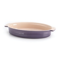 Handcrafted from durable stoneware and boasting 14 of cooking space, this bright Le Creuset oval dish takes your cooking from freezer to oven to table in classic style while a flared rim cuts down on spillage.