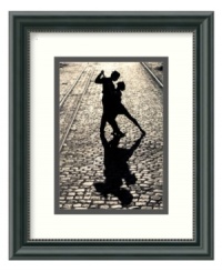 The silhouette of two dancers locked in the final pose of a tango brings drama and passion to a quiet cobblestone street. Light behind the couple casts an elongated shadow at their feet. In classic black and white with a beaded black frame. The silhouette of two dancers locked in the final pose of a tango brings drama and passion to a quiet cobblestone street. Light behind the couple casts an elongated shadow at their feet. In classic black and white with a beaded black frame.