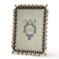 Olivia Riegel Elizabethan Pearl frame for a 4x6 photo. Elegant and refined, the frames faux pearls and intricate enamel banding recall the opulence of Tudor-Stuart England. With hand-set with Swarovski crystals and a decorative metal backside. Olivia Riegel Elizabethan Pearl frame for a 4x6 photo. Elegant and refined, the frames faux pearls and intricate enamel banding recall the opulence of Tudor-Stuart England. With hand-set with Swarovski crystals and a decorative metal backside.