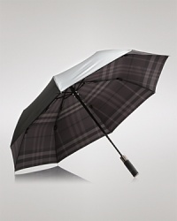 A tonal check pattern lining undergirds this protective umbrella, shading you in signature Burberry style while repelling the rain. A tonal check pattern lining undergirds this protective umbrella, shading you in signature Burberry style while repelling the rain.