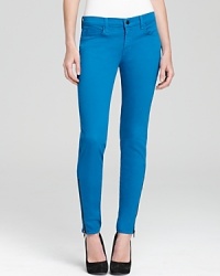 Exposed zips at the ankles lend edge to these J Brand skinny jeans, rendered in a pop-bright hue. Exposed zips at the ankles lend edge to these J Brand skinny jeans, rendered in a pop-bright hue.