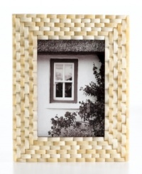 Naturally chic, this Purva picture frame features a thick woven pattern in pure bone, elevating decor with unconventional style and rich texture. Naturally chic, this Purva picture frame features a thick woven pattern in pure bone, elevating decor with unconventional style and rich texture.