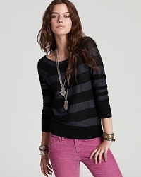 A deep V in front and back, coupled with sparkly metallic stripes, adds a festive flourish to this rugby-inspired Free People sweater. A deep V in front and back, coupled with sparkly metallic stripes, adds a festive flourish to this rugby-inspired Free People sweater.