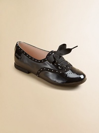 This lustrous patent leather style combines elegance and fun, with dotted trim, wingtip-look perforations and wide grosgrain ribbon laces that tie in pretty bows.Lace-up frontLeather upperLeather solePadded insoleImported This lustrous patent leather style combines elegance and fun, with dotted trim, wingtip-look perforations and wide grosgrain ribbon laces that tie in pretty bows.Lace-up frontLeather upperLeather solePadded insoleImported