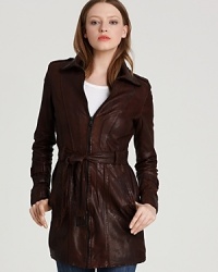 In espresso-stained lamb leather, Andrew Marc's waxed trench gets edgy with raw edge details and stitched trims. A belted waist lends a flattering fit.