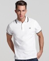 Widely known as the pioneer of Mod, British street fashion, Fred Perry polos have become an iconic fashion silhouette. A sporty polo with contrast double stripe trim and embroidered logo at left chest. Slim fit.