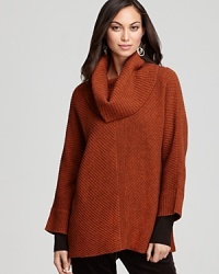 Ushering in a season of separates, this Eileen Fisher sweater makes a bold statement with a swingy silhouette and an oversized cowl neckline. Ushering in a season of separates, this Eileen Fisher sweater makes a bold statement with a swingy silhouette and an oversized cowl neckline.