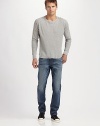 A slim and slouchy fit in medium-wash denim, finished with rips, whiskers, and the look of a well-worn favorite. Five-pocket style Tapered fit with slouchy legs Logo patch on back waist Inseam, about 33 Cotton Machine wash Made in USA 