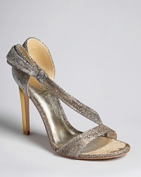 These elegantly chic evening sandals are crafted from a gorgeous metallic fabric that flashes both gold and silver, making this the perfect, versatile pair to take on your next getaway, by IVANKA TRUMP. These elegantly chic evening sandals are crafted from a gorgeous metallic fabric that flashes both gold and silver, making this the perfect, versatile pair to take on your next getaway, by IVANKA TRUMP.