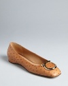 In a luxe ostrich embossed leather with distinctive logo accents, these flats are exotically Salvatore Ferragamo.