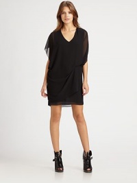 Backed by a semi-sheer cutout back, this sultry silk-like silhouette finishes the look with asymmetrical draping and an overlapping front panel. V-neckShort cutout dolman sleevesAsymmetrical drapingOverlapping front panelBack button closureSemi-sheer cutout backFully linedPolyesterDry cleanImportedModel shown is 5'8 (175cm) wearing US size 4. Backed by a semi-sheer cutout back, this sultry silk-like silhouette finishes the look with asymmetrical draping and an overlapping front panel. V-neckShort cutout dolman sleevesAsymmetrical drapingOverlapping front panelBack button closureSemi-sheer cutout backFully linedPolyesterDry cleanImportedModel shown is 5'8 (175cm) wearing US size 4.