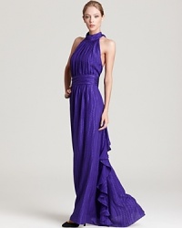 Going somewhere? For any elegant evening affair, look no further than this Milly halter gown. The banded cumberbund waist explodes into cascading ruffles at the back for a truly dramatic detail. Going somewhere? For any elegant evening affair, look no further than this Milly halter gown. The banded cumberbund waist explodes into cascading ruffles at the back for a truly dramatic detail.