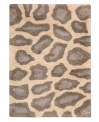 Exotic designs will be the pride of your decor. Adorned with leopard spots in soft beige, this Nourison rug has a marvelously soft and shaggy pile that's hand-tufted from premium-quality yarns. Beautiful in appearance and plush underfoot, this area rug creates an atmosphere of casual elegance. (Clearance)