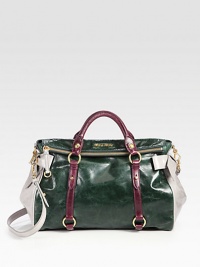 A roomy carryall in beautiful contrast leather with bow embellishments.Double top handles, 5 dropDetachable shoulder strap, 21 dropTop zip closureProtective metal feetOne inside zip pocketThree inside open pocketsSatin lining14W X 9½H X 6½DMade in Italy A roomy carryall in beautiful contrast leather with bow embellishments.Double top handles, 5 dropDetachable shoulder strap, 21 dropTop zip closureProtective metal feetOne inside zip pocketThree inside open pocketsSatin lining14W X 9½H X 6½DMade in Italy