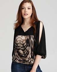 An animal print of rich silk lends exotic chic to this Akiko top, accented with slit sleeves. An animal print of rich silk lends exotic chic to this Akiko top, accented with slit sleeves.