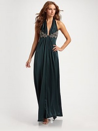 The luxury of silk, in a sexy halter style with a plunging front and jeweled detailing.Tie-back halter Pleated bodice with jeweled medallions Softly pleated flowing skirt Low back Back zip closure Rolled hem About 45 from natural waist Silk Dry clean ImportedOUR FIT MODEL RECOMMENDS ordering true size. The luxury of silk, in a sexy halter style with a plunging front and jeweled detailing.Tie-back halter Pleated bodice with jeweled medallions Softly pleated flowing skirt Low back Back zip closure Rolled hem About 45 from natural waist Silk Dry clean ImportedOUR FIT MODEL RECOMMENDS ordering true size.