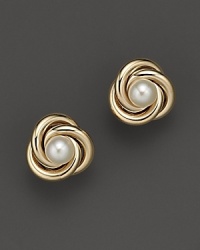 A gleaming cultured pearl rests in a nest of coiled 14K yellow gold. A gleaming cultured pearl rests in a nest of coiled 14K yellow gold.