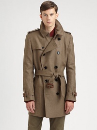 Featuring clever details and classic tailoring, a belted trenchcoat made from virgin wool.Notched collarGunflapButton closureBack yokeRainflapBack ventsAbout 35 from shoulder to hemVirgin woolDry cleanImported of Italian fabric