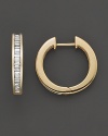 A channel set row of baguette diamonds ignite this stunning hoop earring in 14 Kt. yellow gold.