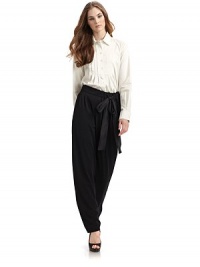 THE LOOKShirt collarFront button placketLong button cuff sleeves with pleated detailsPleated bib yokeU-shaped hemTHE FITAbout 25 from shoulder to longest point of hemTHE MATERIAL96% cotton/4% other fibersCARE & ORIGINDry cleanMade in Italy THE LOOKShirt collarFront button placketLong button cuff sleeves with pleated detailsPleated bib yokeU-shaped hemTHE FITAbout 25 from shoulder to longest point of hemTHE MATERIAL96% cotton/4% other fibersCARE & ORIGINDry cleanMade in Italy