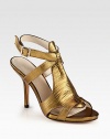 Rippled metallic leather forms this seductive silhouette, with a slender heel and adjustable ankle strap. Self-covered heel, 4 (100mm)Covered platform, ½ (15mm)Compares to a 3½ heel (90mm)Reptile-embossed metallic leather upperAdjustable ankle strapLeather lining and solePadded insoleImported