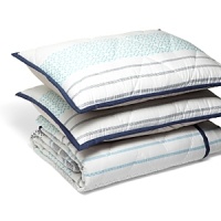 Inspired by Polynesian block prints, this coverlet set echoes the islands with coastal colors of blue and turquoise in repeating geometric patterns and trim. A chevron-stitched quilting pattern adds visual interest. Inspired by Polynesian block prints, this coverlet set echoes the islands with coastal colors of blue and turquoise in repeating geometric patterns and trim. A chevron-stitched quilting pattern adds visual interest.