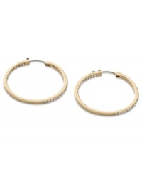 These timeless hoop earrings from Fossil get a glitzy upgrade with black diamond crystal accents. Crafted in shiny gold tone mixed metal. Approximate diameter: 1-3/8 inches. These timeless hoop earrings from Fossil get a glitzy upgrade with black diamond crystal accents. Crafted in shiny gold tone mixed metal. Approximate diameter: 1-3/8 inches.