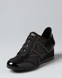 Exploring new cities or just doing errands, these DKNY sneakers lend casual polish to your look, keeping pace with the athletic-meets-casual trend. Exploring new cities or just doing errands, these DKNY sneakers lend casual polish to your look, keeping pace with the athletic-meets-casual trend.