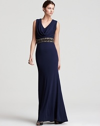 This Badgley Mischka gown evokes modern glamour with an opulent jeweled waist and elegant draped neck. This Badgley Mischka gown evokes modern glamour with an opulent jeweled waist and elegant draped neck.