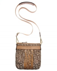 Soft leather trim and subtle zebra design add graphic contrast to the signature jacquard fabric of this go-anywhere Calvin Klein design. Pockets inside and out keep you well-organized, while the adjustable strap is easily removed to transform this crossbody into a clutch.