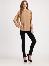 Basic silk shirt roughened by cutout sleeves and a long silhouette. Point collarHidden button frontLong, open sleevesButtoned cuffsLonger length hits below the hipsSilkDry cleanImportedModel shown is 5'10 (177cm) wearing US size Small. Basic silk shirt roughened by cutout sleeves and a long silhouette. Point collarHidden button frontLong, open sleevesButtoned cuffsLonger length hits below the hipsSilkDry cleanImportedModel shown is 5'10 (177cm) wearing US size Small.