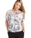A soft watercolor print and feminine pleats at the back brings a daintiness to this petite blouse from Alfani.