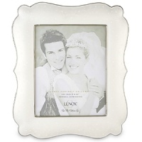Opal Innocence, the popular china pattern from Lenox, lends a romantic feel to this fine china frame. Here, pearl-like enamel dots are elegant against an opalescent background. The frame, trimmed in precious platinum, makes a perfect engagement or wedding gift. Frame is crafted of Lenox white bone china accented with precious platinum and holds one 8 x 10 photo.Height: 14 1/2