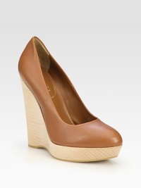 Lustrous leather slide with an ultra-high stacked wedge and rubber sole for traction. Stacked wooden wedge, 5½ (140mm)Covered platform, 1½ (40mm)Compares to a 4 heel (100mm)Leather upperLeather liningRubber solePadded insoleMade in ItalyOUR FIT MODEL RECOMMENDS ordering one half size up as this style runs small. Lustrous leather slide with an ultra-high stacked wedge and rubber sole for traction. Stacked wooden wedge, 5½ (140mm)Covered platform, 1½ (40mm)Compares to a 4 heel (100mm)Leather upperLeather liningRubber solePadded insoleMade in ItalyOUR FIT MODEL RECOMMENDS ordering one half size up as this style runs small.
