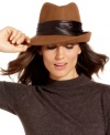 Top off any outfit with a classic, like this felt fedora from Nine West. The asymmetrical style is trimmed with contrasting ribbon, for an altogether alluring look.