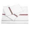 Our 300-thread count cotton sateen sheet set featured embroidered dots in berry red along the flat sheet and pillowcases. Set includes one flat sheet, one fitted sheet and two pillowcases.