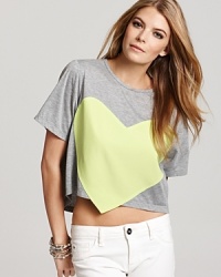 This Laugh Cry Repeat tee flaunts an electric-hued woven heart for a high-voltage pop of color.