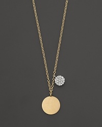 This gold medallion necklace is paired with a mini diamond pavé medallion. Designed by Meira T. This gold medallion necklace is paired with a mini diamond pavé medallion. Designed by Meira T.