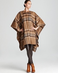 Positively decadent, this MICHAEL Michael Kors coat ushers in rustic elegance with a oversized plaid pattern and heritage buckle closure. Positively decadent, this MICHAEL Michael Kors coat ushers in rustic elegance with a oversized plaid pattern and heritage buckle closure.