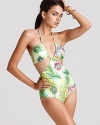 Nanette Lepore's daring peacock print monokini with beads makes a sultry splash. Complete a flirtatious pool side look by teaming this once piece with oversizd shades and flat sandals.