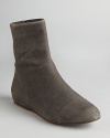 Streamlined stretch and sensual suede define these See by Chloé flat booties.