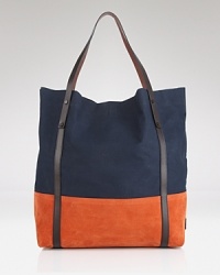 In a modern color-block design, this roomy Burberry tote is ideal for both errands and travel. In a modern color-block design, this roomy Burberry tote is ideal for both errands and travel.