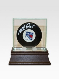 After a grueling 54 years without the Stanley Cup and seven stomach-churning finals games, the New York Rangers finally conquered the championship in 1994. As goaltender for the Rangers, Mike Richter's unwavering performance proved an essential part of the winning equation. Mike Richter has hand-signed this New York Rangers hockey puck and arrives in a glass/wood display case. Includes certificate of authenticity 8 X 8 X 8 Made in USA 